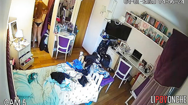 The long-haired redhead strips completely naked while trying on new swimsuits
