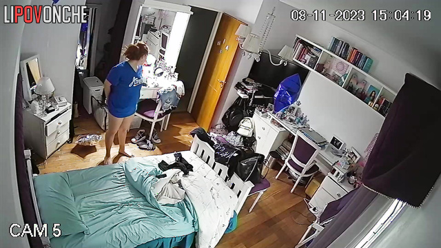 A pretty girl pulls down her panties and examines her shaved pussy in a makeup mirror