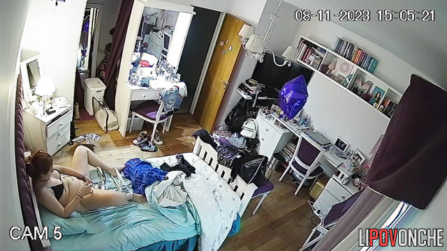 A pretty girl pulls down her panties and examines her shaved pussy in a makeup mirror