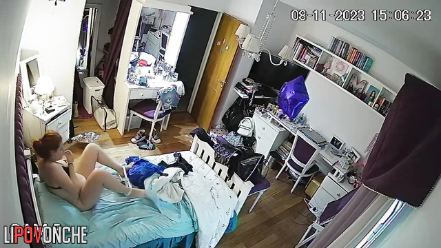 A pretty girl pulls down her panties and examines her shaved pussy in a makeup mirror