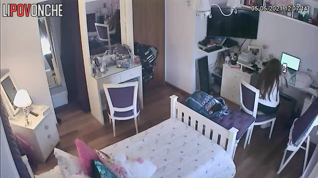 A pretty girl is masturbating on the bed, periodically distracted by messaging