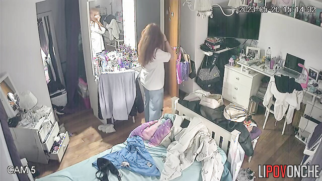 A long-haired cutie bares her perky breasts as she changes her bra