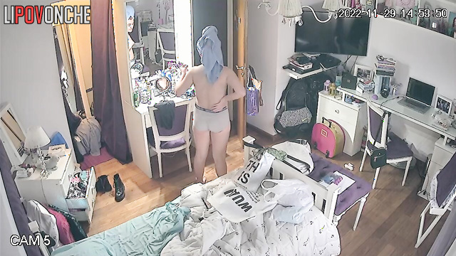 After her shower, the redhead walks around the room wearing nothing but her panties