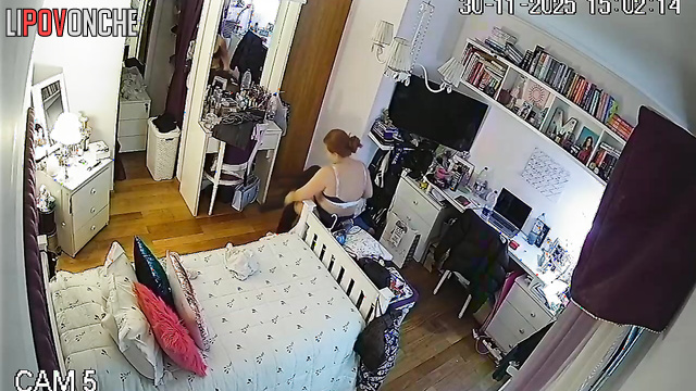 A seductive young woman admires her reflection after trying on a new bra