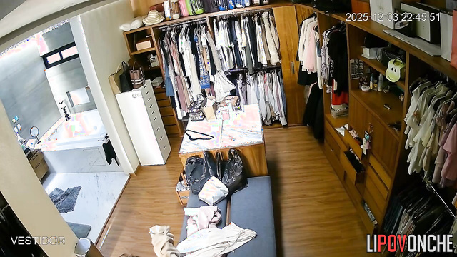 Hidden camera footage from a locker room showing a brunette undressing
