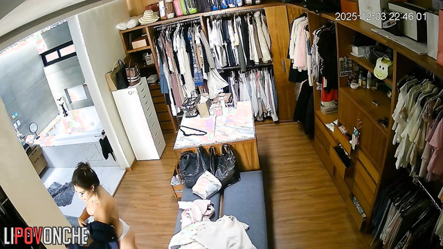 Hidden camera footage from a locker room showing a brunette undressing