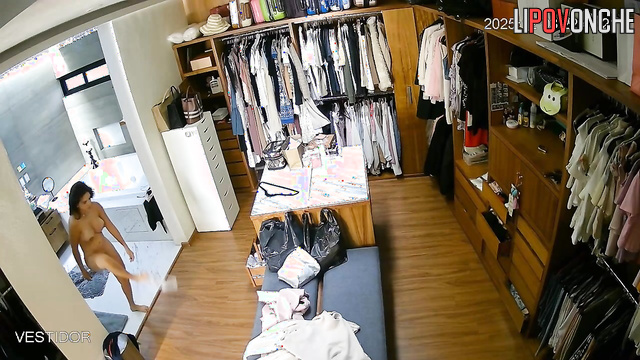 Hidden camera footage from a locker room showing a brunette undressing