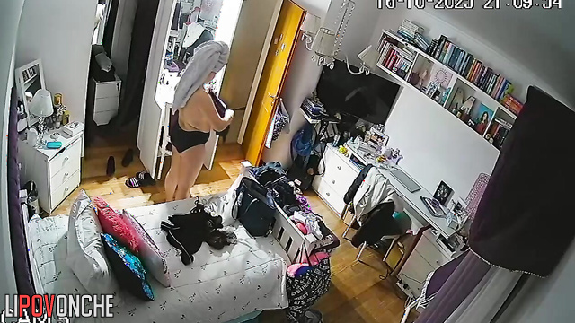 A naked beauty with a curvy butt walks around the room with her panties down