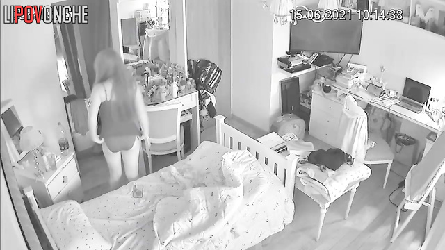 A cute, charming girl sniffs a deodorant can after pulling it out of her vagina