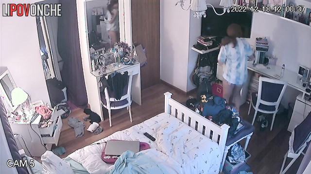 A red-haired girl in a sexy bra gazes lustfully at her reflection in the mirror