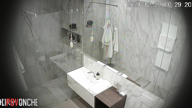 An athletic girl is vigorously lathering up her hairy pussy in the shower