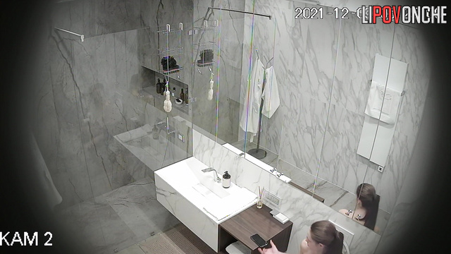 After peeing, a naked beauty with a hairy pussy takes a shower