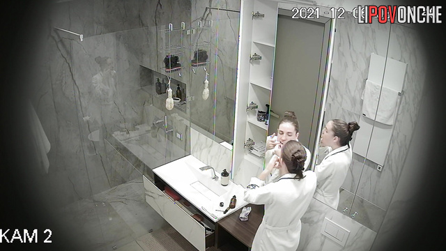 A skinny girl is vigorously rubbing her sexy body under the shower stream