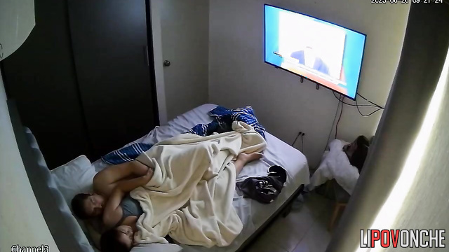 An aroused man secretly starts caressing a young brunette's butt while she sleeps