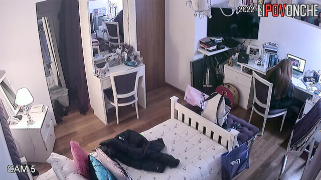 A young girl with red hair stripped down to her underwear while trying on a dress
