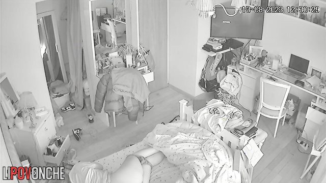 A red-haired teenage girl is lying on her bed with her panties down