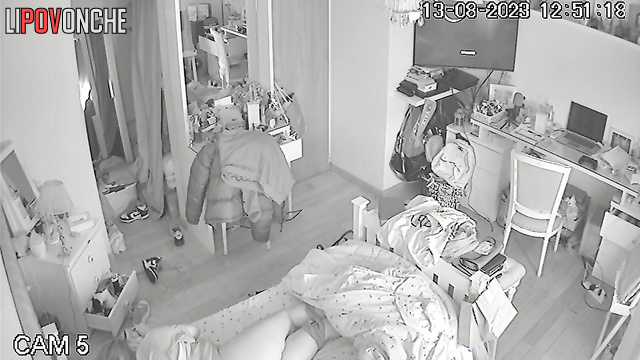 A red-haired teenage girl is lying on her bed with her panties down