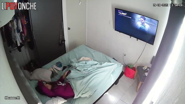 A brunette is messaging on her phone while she has a vibrator inside her cunt