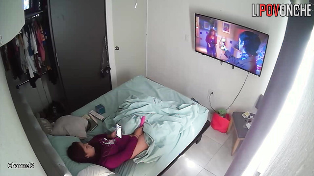 A brunette is messaging on her phone while she has a vibrator inside her cunt