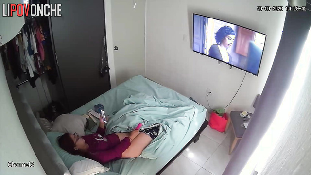A brunette is messaging on her phone while she has a vibrator inside her cunt