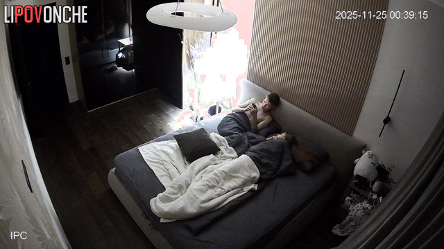 A naked, skinny girl caresses her buttocks before getting into bed