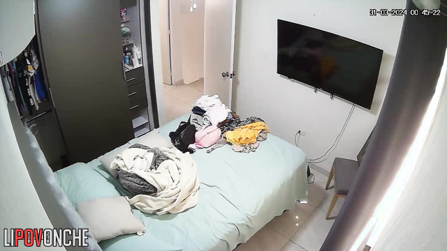A completely naked brunette is relaxing on the bed after a shower