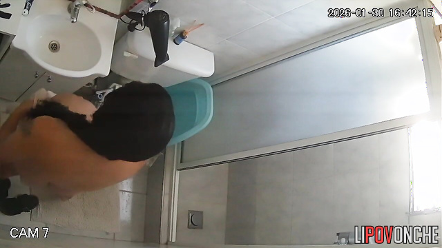 After peeing, the girl wipes her cunt with her nightgown and goes to take a shower