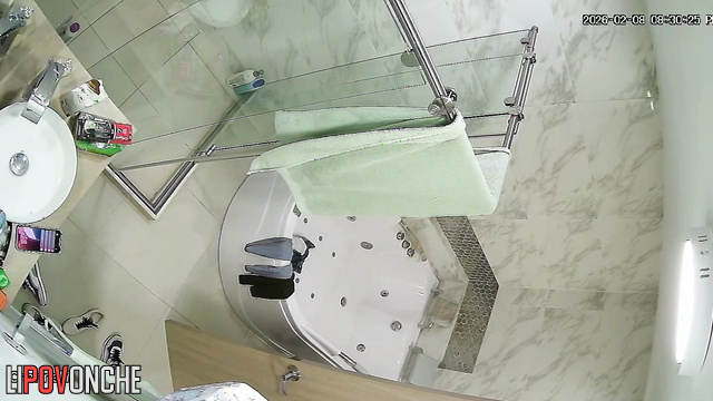 A hidden camera in the shower captured the stunning body of a young brunette