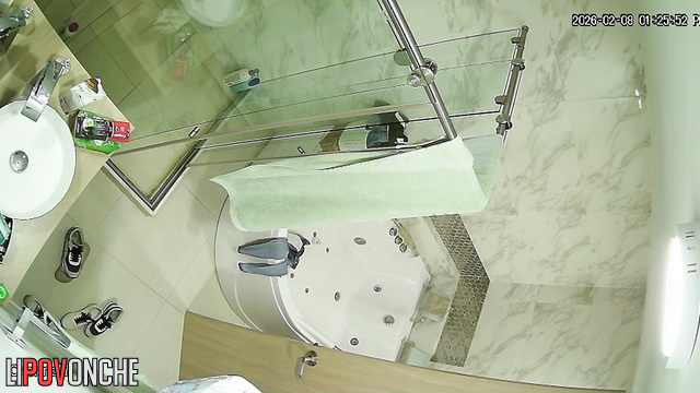 The transparent shower stall does nothing to hide the sexy brunette's naked body
