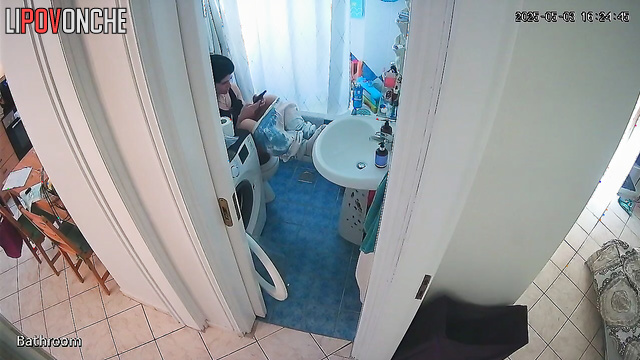 A sexy brunette arches seductively, washing her inviting butt
