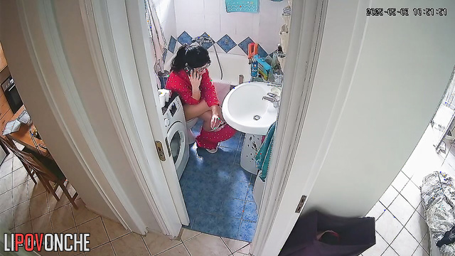 After cleaning, the housewife pulled down her pants and sat on the toilet