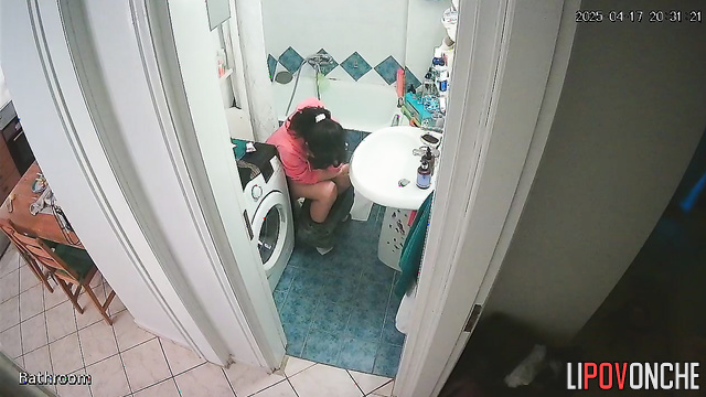 A girl, sitting on the toilet without panties, lifts her sexy legs high