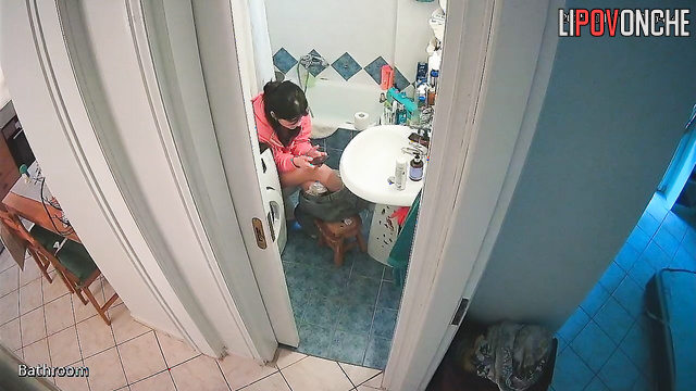After pooping, a beautiful brunette washes her delicate, sexy ass
