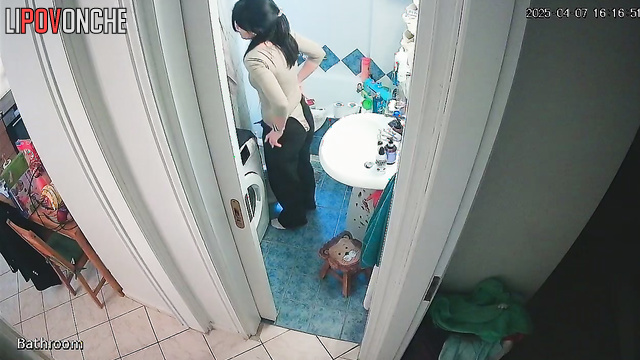 A cute brunette bares her sexy butt and shaved pussy while talking on the phone