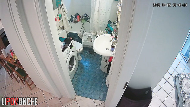 A pretty housewife washes her butt while talking on the phone