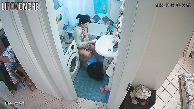A cute girl pulls down her panties and is completely focused on peeing