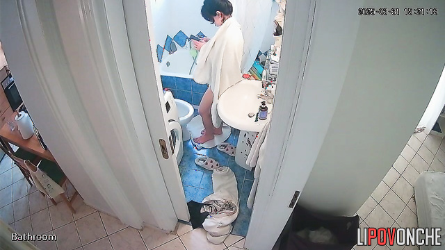 A brunette with a sexy butt is cleaning the toilet without panties
