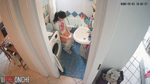 After tidying up the bathroom, the pretty girl quickly takes a pee
