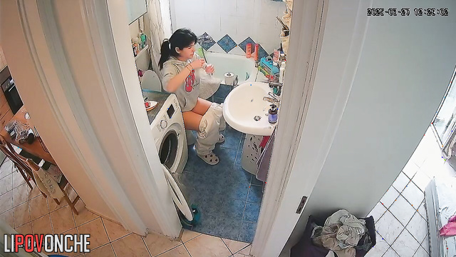 After tidying up the bathroom, the pretty girl quickly takes a pee