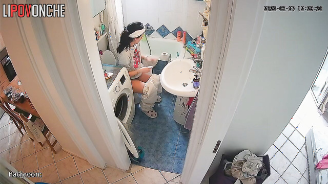 After tidying up the bathroom, the pretty girl quickly takes a pee
