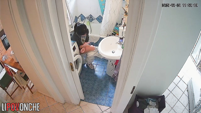 A gorgeous girl is watching porn on her phone while sitting on the toilet