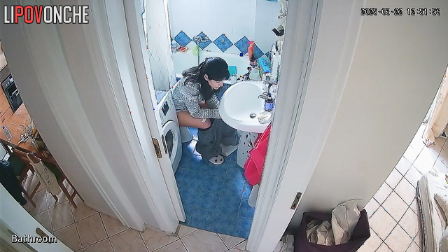Cutie seductively pulls her pants down over her bottom as she sits down on the toilet