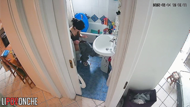After cleaning the apartment, the cute brunette bares her sexy ass in the restroom