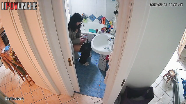 After peeing, the pretty brunette wipes her wet pussy and examines the napkin