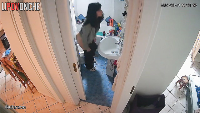 After peeing, the pretty brunette wipes her wet pussy and examines the napkin