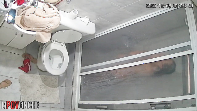 A tattooed blonde undressing in the shower has no idea she's being filmed