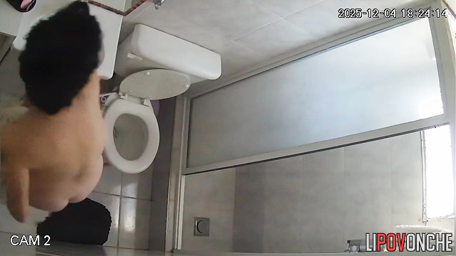A hidden camera captured the sexy butt of a brunette washing herself in the shower