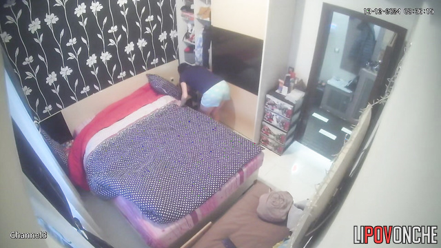 A hidden camera captured a young brunette undressing while her husband wasn't home