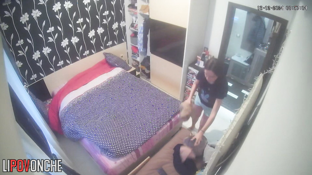 A hidden camera captured a young brunette undressing while her husband wasn't home