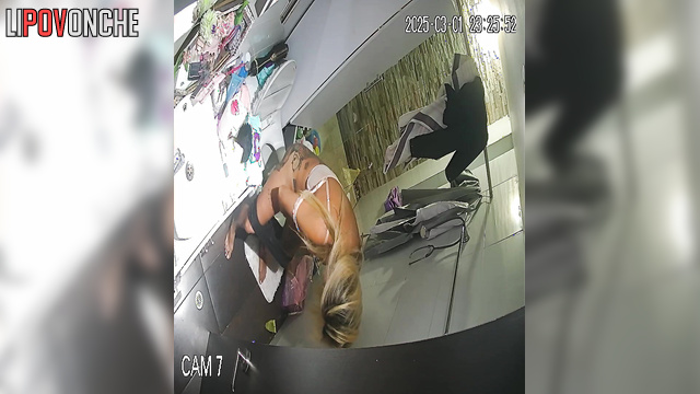 A half-asleep blonde checks her messages on her smartwatch while peeing